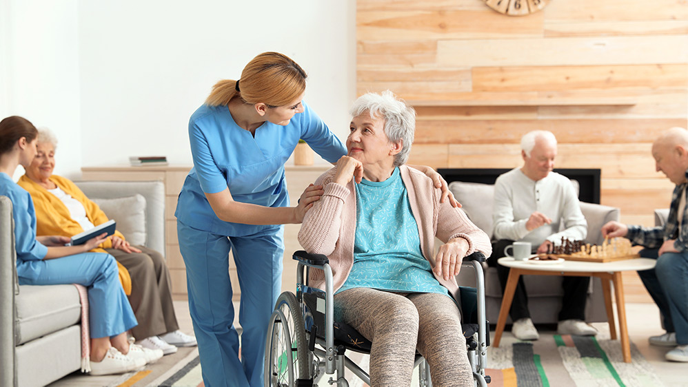 Elder woman in care home with carer