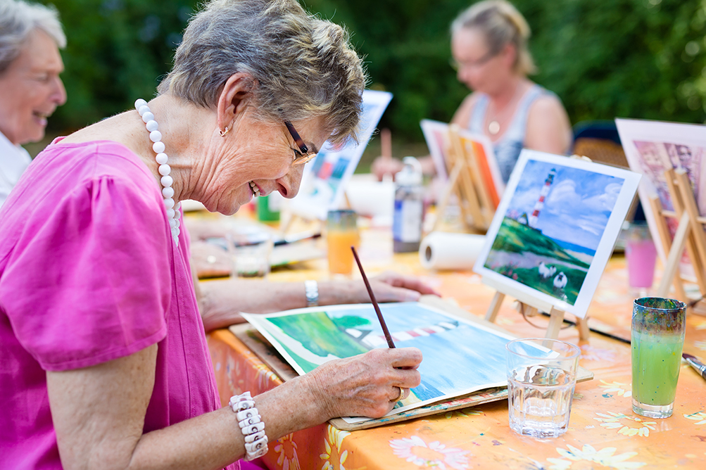 Group of elderly people painting together