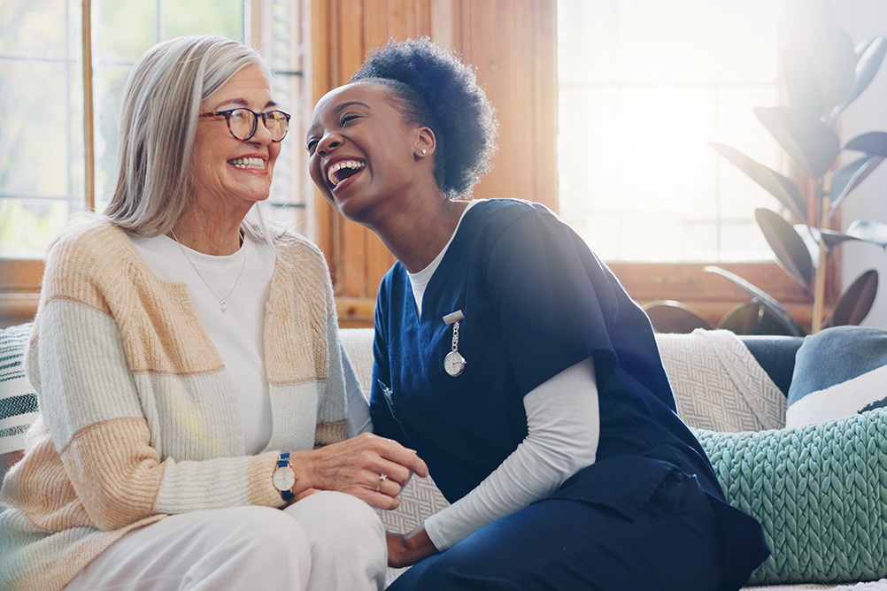 Smiling senior woman and care worker