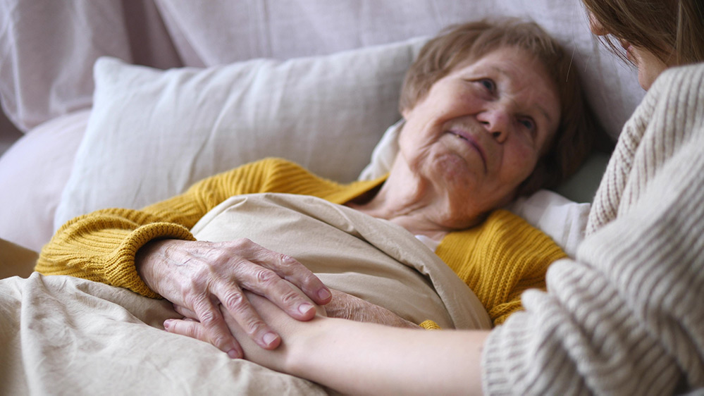 Elder woman in palliative care resting in bed